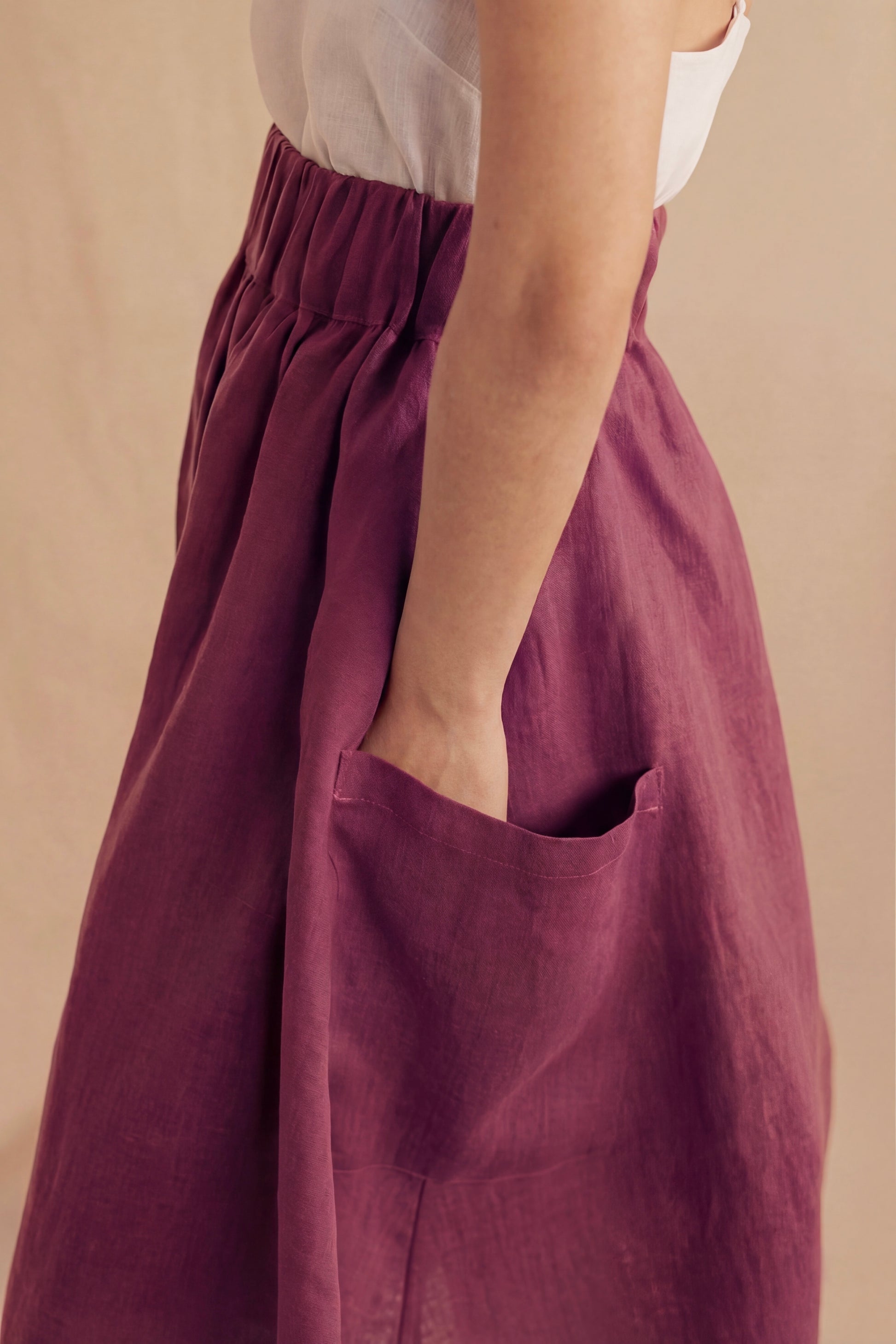 Purple pants with a pocket on a beige background